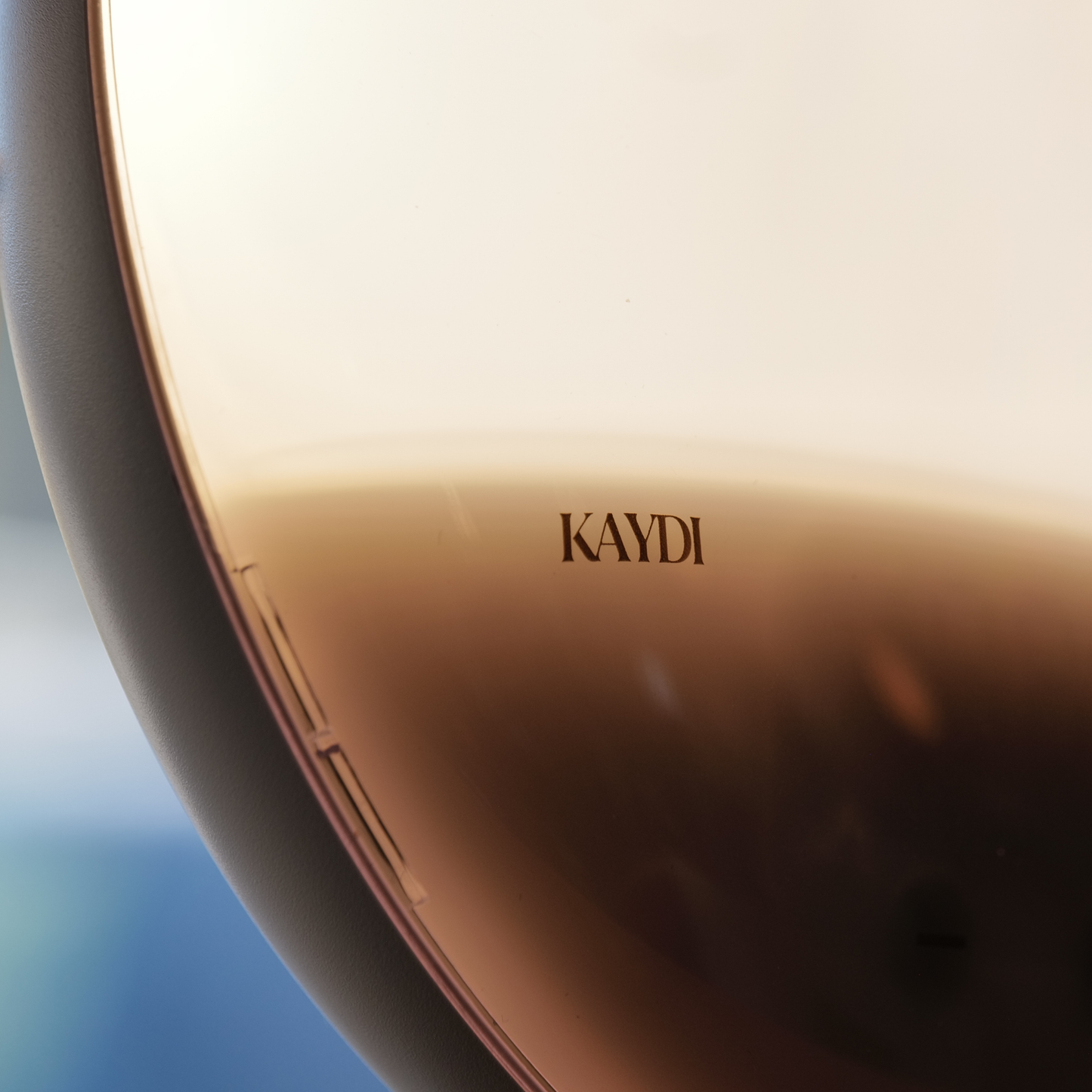 Close up of Kaydi One wake up light showing warm gradient sunrise light and Kaydi logo on the front.