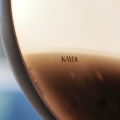 Close up of Kaydi One wake up light showing warm gradient sunrise light and Kaydi logo on the front.