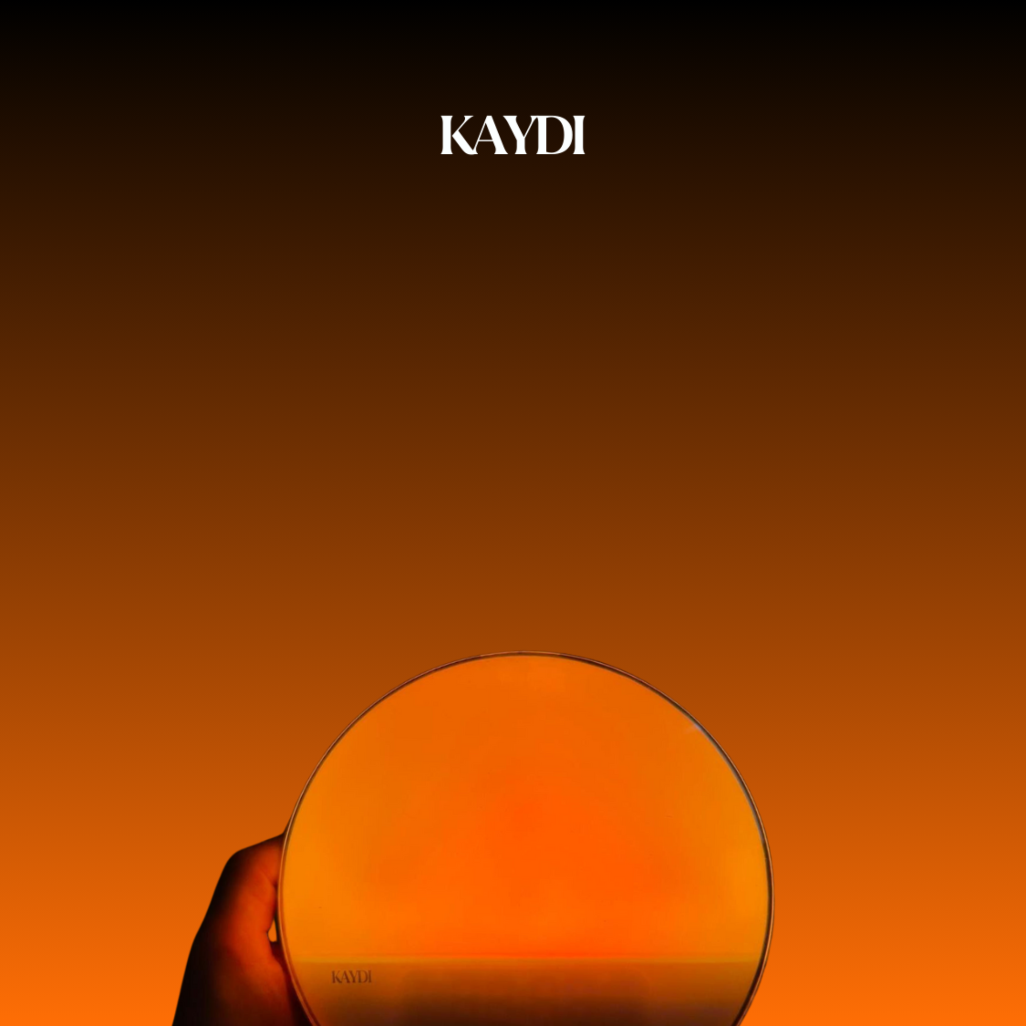 Kaydi wake up light glowing warm orange against a gradient background with a hand holding the base and the Kaydi logo above.